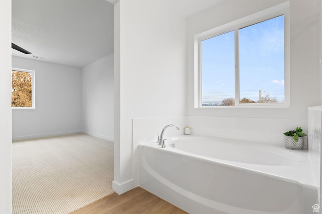 695 N Plainsman Dr Unit 110, Spanish Fork, UT 84660 - full bathroom with a bath, wood finished floors, plenty of natural light, and baseboards