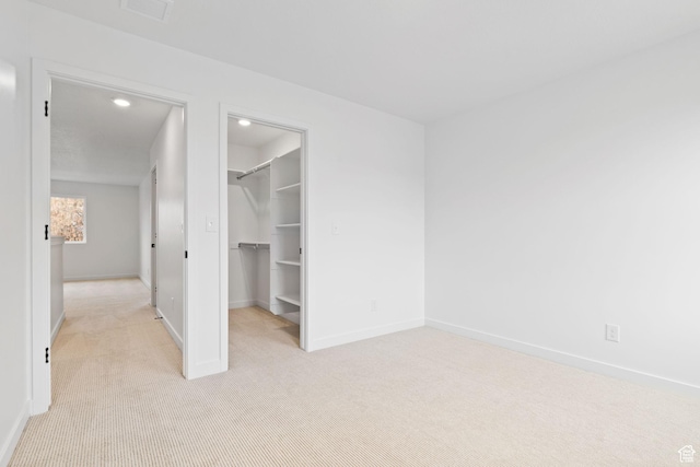 695 N Plainsman Dr Unit 110, Spanish Fork, UT 84660 - unfurnished bedroom with a spacious closet, baseboards, and light colored carpet