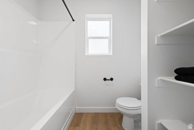 695 N Plainsman Dr Unit 110, Spanish Fork, UT 84660 - full bathroom featuring toilet, wood finished floors, and baseboards