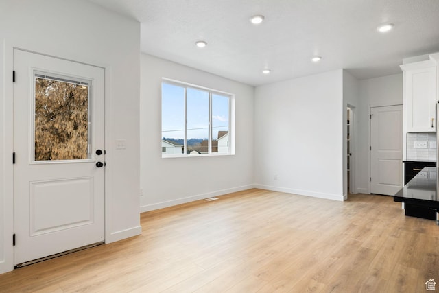 695 N Plainsman Dr Unit 110, Spanish Fork, UT 84660 - unfurnished living room featuring light wood-type flooring, baseboards, and recessed lighting
