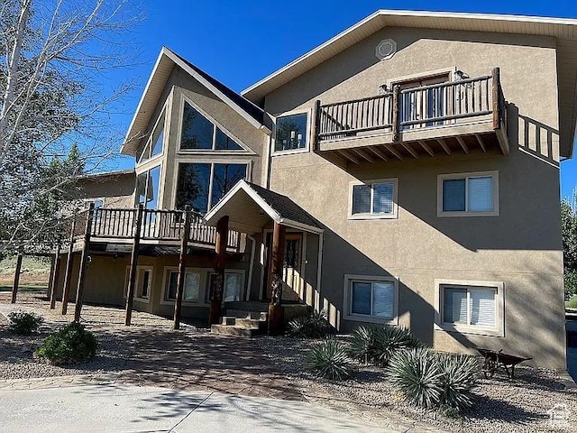 back of property featuring stucco siding and a balcony
