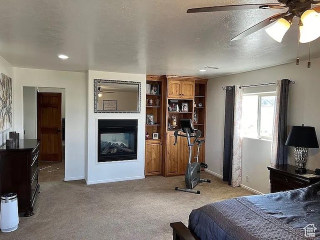 1345 W 1625 S, Price, UT 84501 - carpeted bedroom with baseboards, ceiling fan, a multi sided fireplace, and a textured ceiling