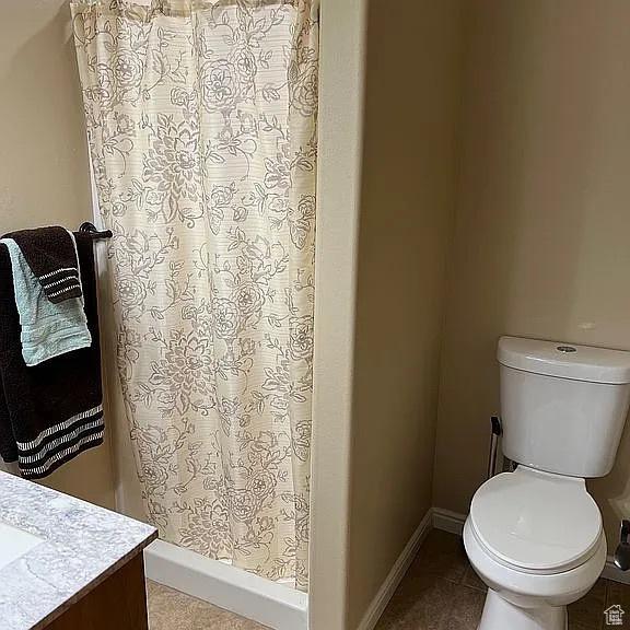 1345 W 1625 S, Price, UT 84501 - bathroom with a shower stall, toilet, tile patterned flooring, and vanity