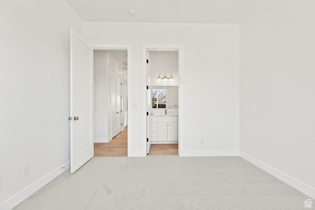 1522 N Zion Cir, Apple Valley, UT 84737 - unfurnished bedroom with light carpet, baseboards, and ensuite bath