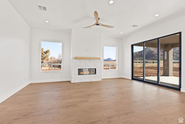 1522 N Zion Cir, Apple Valley, UT 84737 - unfurnished living room with a tiled fireplace, wood finished floors, baseboards, and visible vents