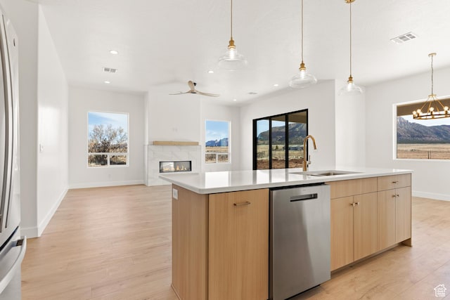 1522 N Zion Cir, Apple Valley, UT 84737 - kitchen featuring light brown cabinets, open floor plan, a sink, and dishwasher