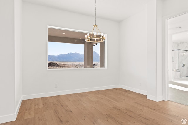 1522 N Zion Cir, Apple Valley, UT 84737 - unfurnished dining area featuring baseboards, wood finished floors, and a notable chandelier