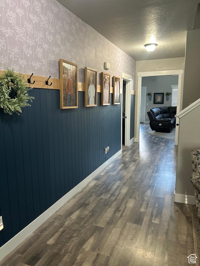 13907 S Birch Leaf W, Herriman, UT 84096 - hallway with dark wood-type flooring, baseboards, a textured ceiling, and wallpapered walls