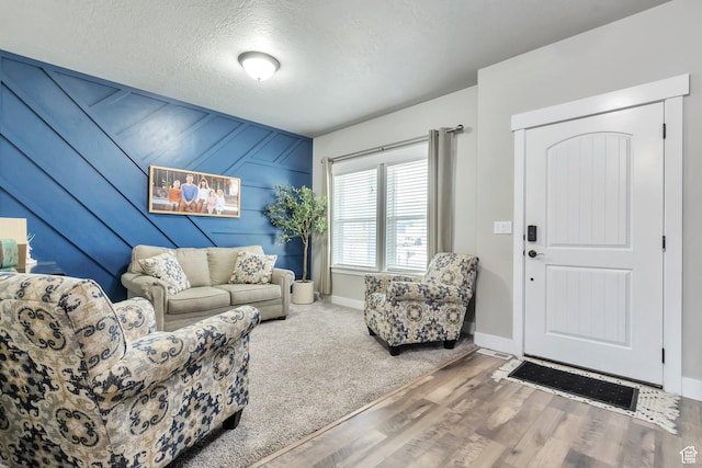 13907 S Birch Leaf W, Herriman, UT 84096 - living room with wood walls, a textured ceiling, baseboards, and wood finished floors
