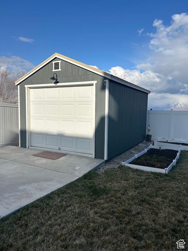 13907 S Birch Leaf W, Herriman, UT 84096 - garage featuring a garden, concrete driveway, and fence