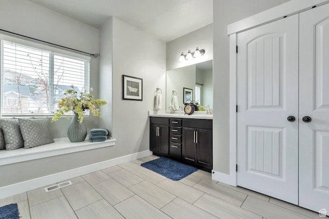 13907 S Birch Leaf W, Herriman, UT 84096 - bathroom with double vanity, a sink, baseboards, and visible vents