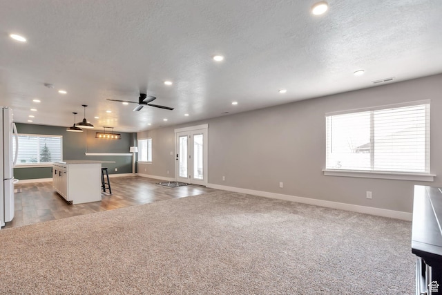 13907 S Birch Leaf W, Herriman, UT 84096 - kitchen with freestanding refrigerator, a breakfast bar, open floor plan, light colored carpet, and ceiling fan