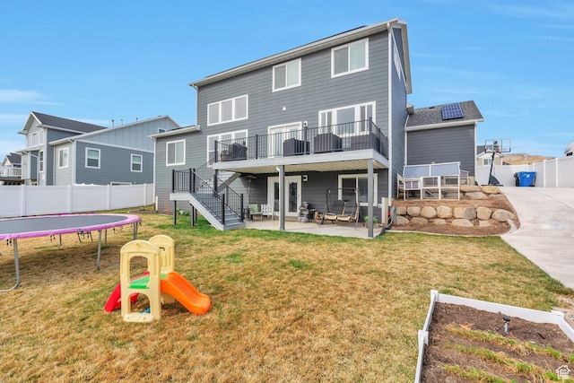 13907 S Birch Leaf W, Herriman, UT 84096 - rear view of house with fence, a patio, a trampoline, a playground, and a yard