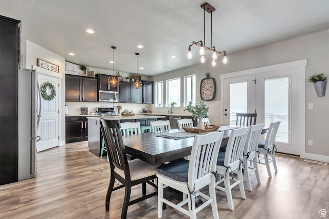 13907 S Birch Leaf W, Herriman, UT 84096 - dining area featuring baseboards, light wood-style flooring, and recessed lighting