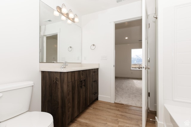 3291 S 1000 W, Nibley, UT 84321 - full bathroom with vanity, toilet, baseboards, visible vents, and wood finished floors