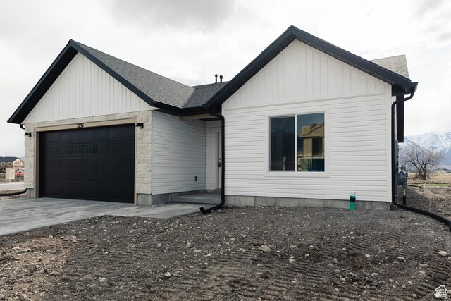 3291 S 1000 W, Nibley, UT 84321 - modern inspired farmhouse with driveway, a shingled roof, a garage, and board and batten siding