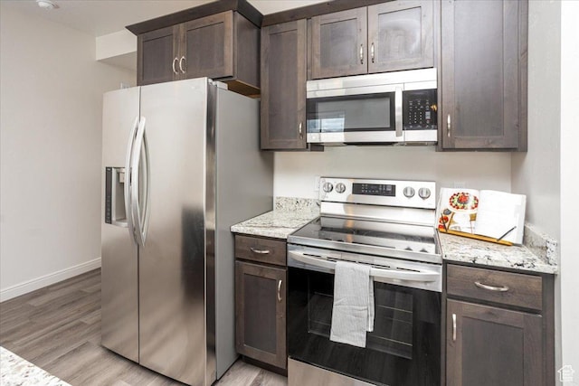 250 W 1200 S Unit 118, Tremonton, UT 84337 - kitchen with dark brown cabinets, appliances with stainless steel finishes, baseboards, and light wood finished floors