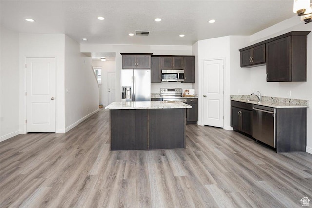 250 W 1200 S Unit 118, Tremonton, UT 84337 - kitchen featuring a sink, a center island, light wood-type flooring, stainless steel appliances, and dark brown cabinets