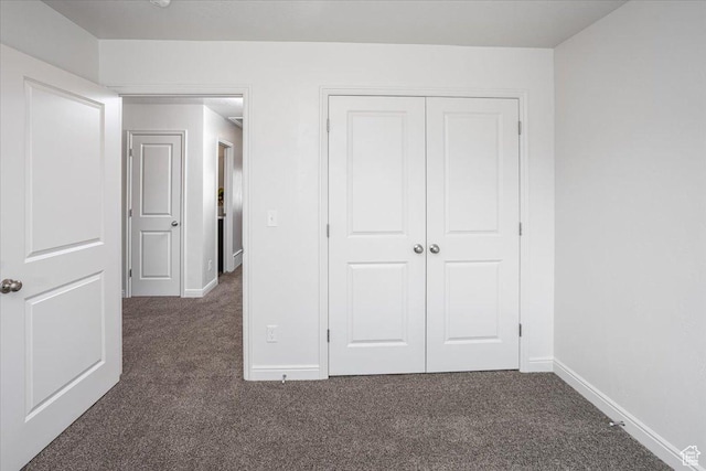 250 W 1200 S Unit 118, Tremonton, UT 84337 - unfurnished bedroom featuring a closet, baseboards, and dark carpet