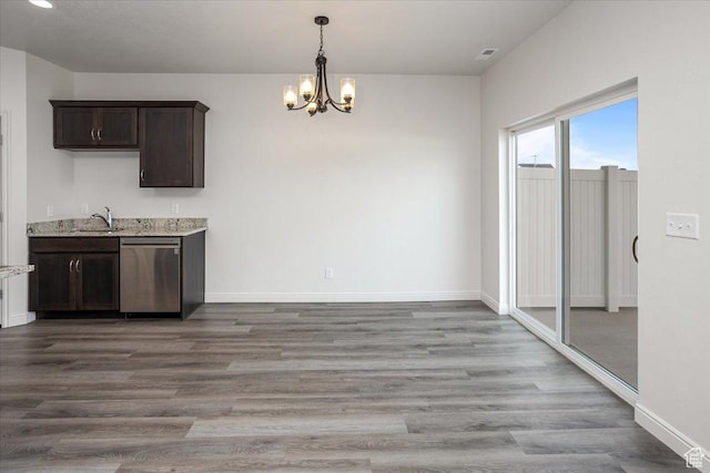 250 W 1200 S Unit 118, Tremonton, UT 84337 - unfurnished dining area featuring baseboards, a sink, an inviting chandelier, and wood finished floors