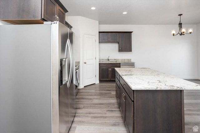 250 W 1200 S Unit 118, Tremonton, UT 84337 - kitchen featuring dark brown cabinetry, appliances with stainless steel finishes, a center island, and wood finished floors