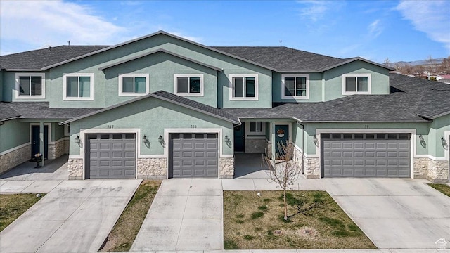 250 W 1200 S Unit 118, Tremonton, UT 84337 - view of front facade with driveway, stone siding, and stucco siding