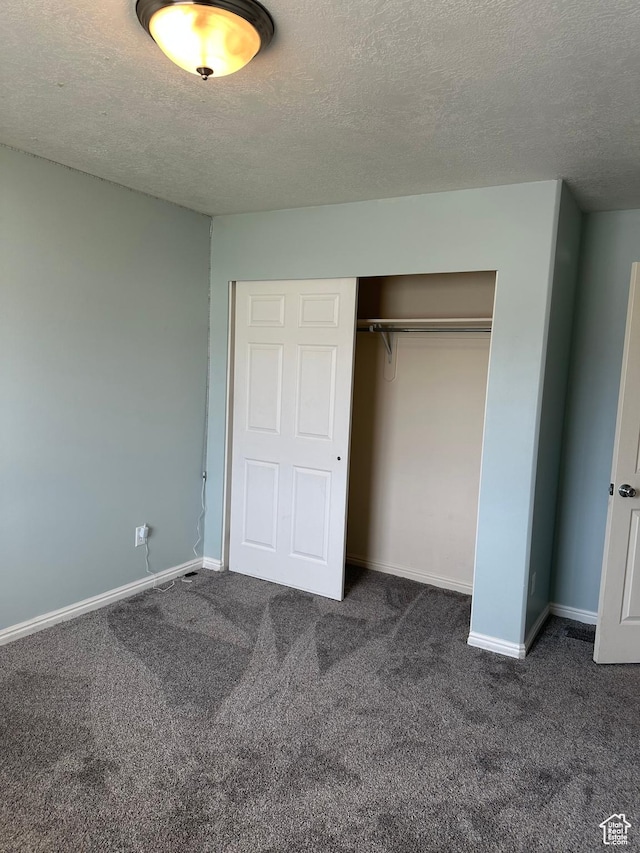 706 S 1690 W, Logan, UT 84321 - unfurnished bedroom with baseboards, a closet, carpet flooring, and a textured ceiling