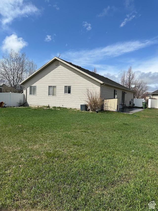 706 S 1690 W, Logan, UT 84321 - view of home's exterior with a patio area, central AC, fence, and a lawn