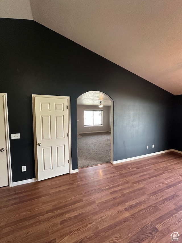 706 S 1690 W, Logan, UT 84321 - unfurnished room featuring arched walkways, baseboards, a textured ceiling, and wood finished floors