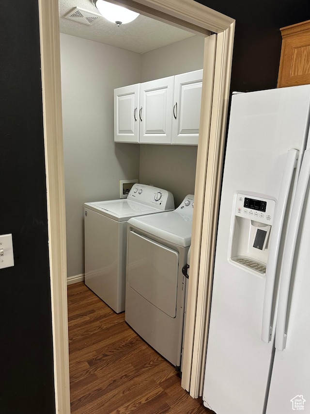 706 S 1690 W, Logan, UT 84321 - laundry area featuring washing machine and clothes dryer, cabinet space, visible vents, and dark wood finished floors