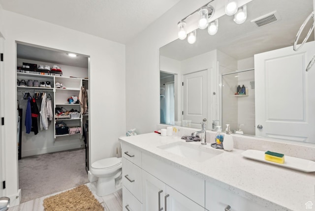 795 N Brook Ave, Tooele, UT 84074 - bathroom with toilet, vanity, a shower stall, a spacious closet, and visible vents
