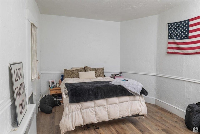 263 W Center St, Logan, UT 84321 - bedroom with wood finished floors and a textured wall