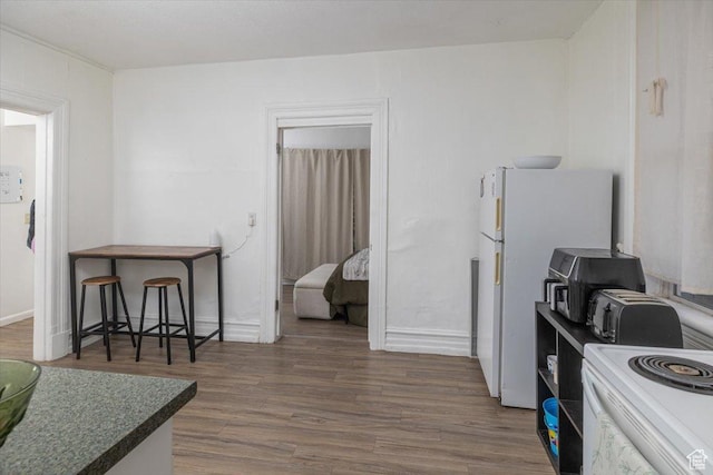263 W Center St, Logan, UT 84321 - kitchen with white appliances, wood finished floors, and baseboards