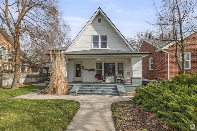 263 W Center St, Logan, UT 84321 - bungalow with a front lawn, covered porch, and fence
