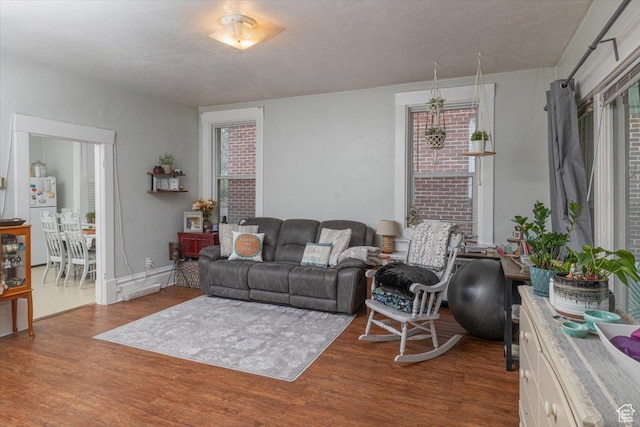 263 W Center St, Logan, UT 84321 - living area with a textured ceiling, baseboards, and wood finished floors