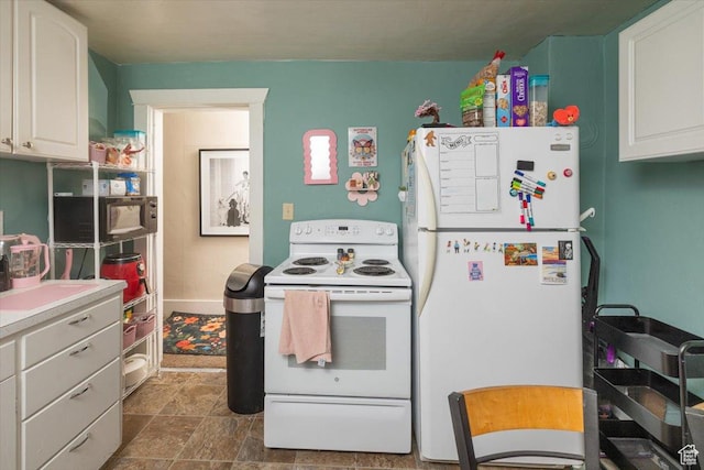 263 W Center St, Logan, UT 84321 - kitchen with white cabinets, light countertops, and white appliances