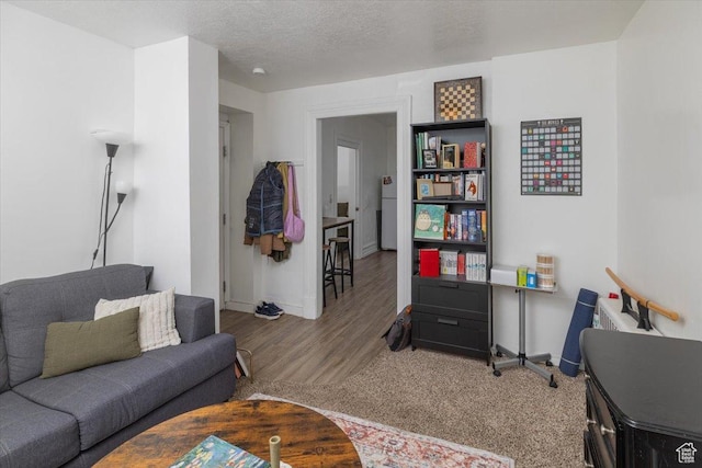 263 W Center St, Logan, UT 84321 - living area with baseboards, wood finished floors, and a textured ceiling