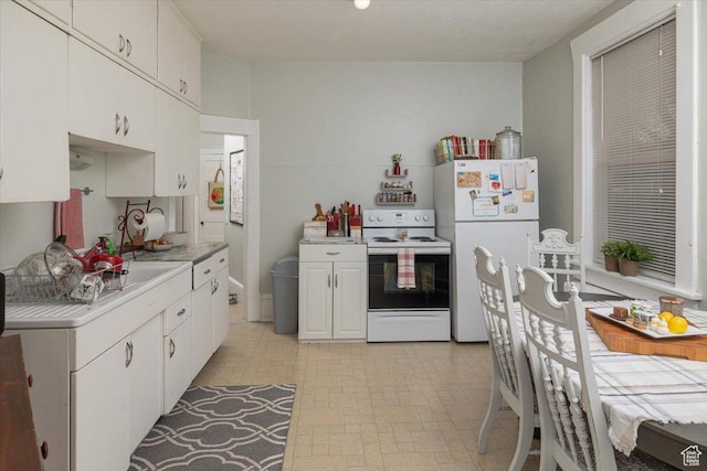 263 W Center St, Logan, UT 84321 - kitchen featuring white appliances, white cabinetry, and light countertops