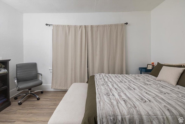 263 W Center St, Logan, UT 84321 - bedroom featuring baseboards and wood finished floors