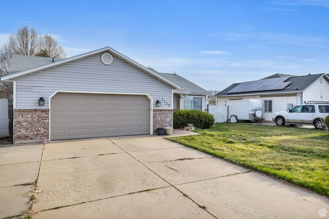view of front facade with concrete driveway, a front yard, brick siding, and a garage