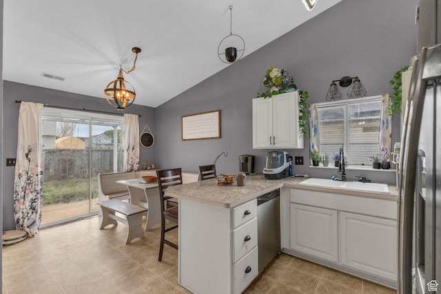 kitchen featuring stainless steel dishwasher, visible vents, white cabinetry, a peninsula, and vaulted ceiling