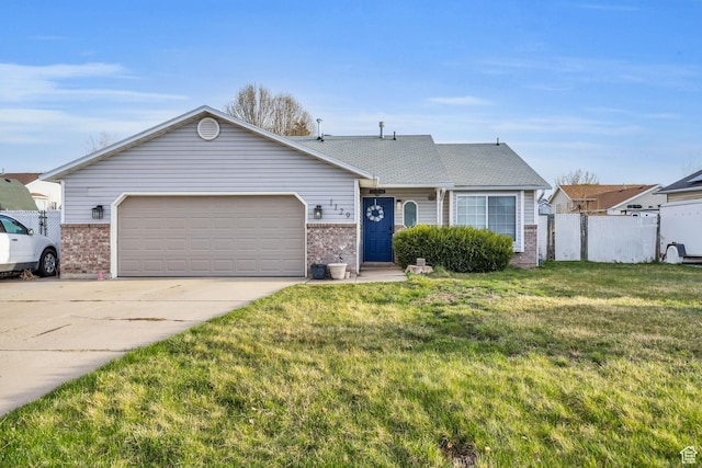 ranch-style house featuring fence, an attached garage, concrete driveway, a front yard, and brick siding