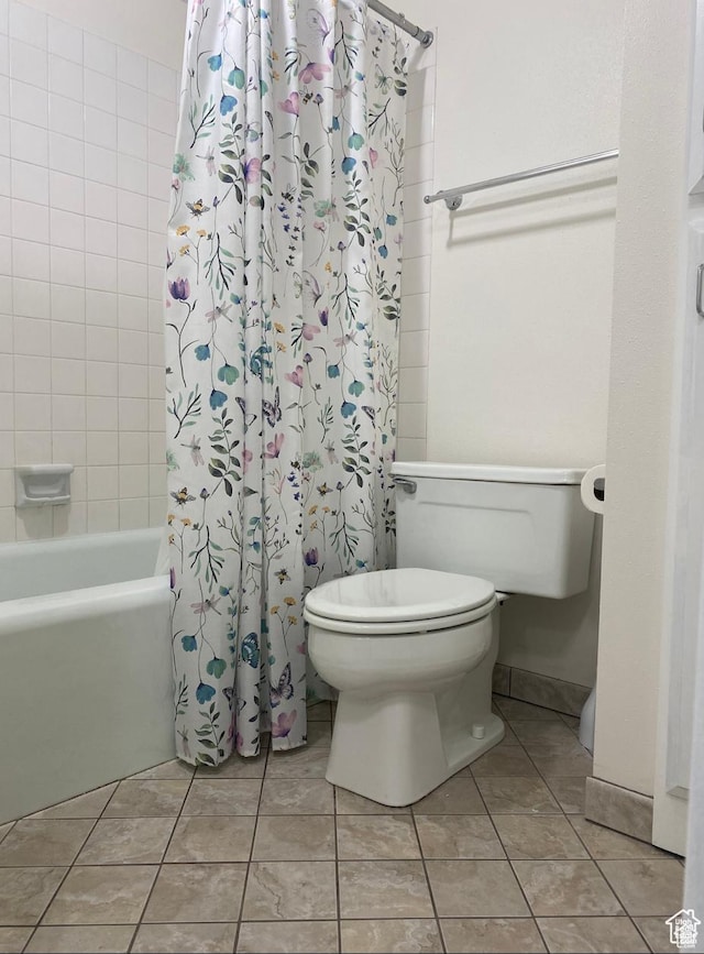 bathroom featuring toilet, tile patterned flooring, and shower / bath combo