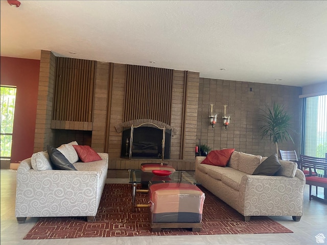 living area featuring a textured ceiling and a fireplace