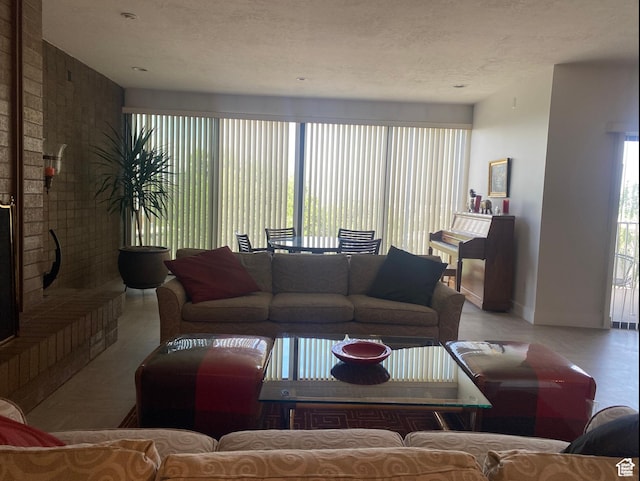 tiled living room featuring a textured ceiling