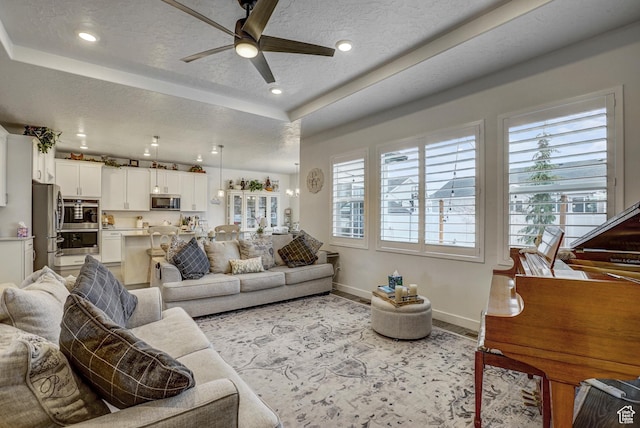 1002 E 2680 S, Heber City, UT 84032 - living room featuring a tray ceiling, a textured ceiling, ceiling fan, and a wealth of natural light