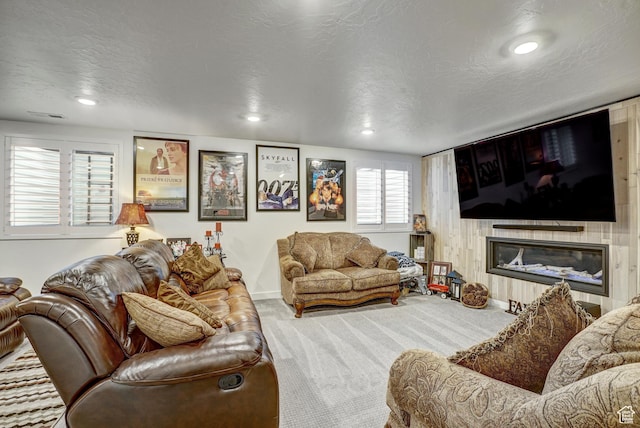 1002 E 2680 S, Heber City, UT 84032 - carpeted living room with visible vents, a textured ceiling, a glass covered fireplace, and recessed lighting
