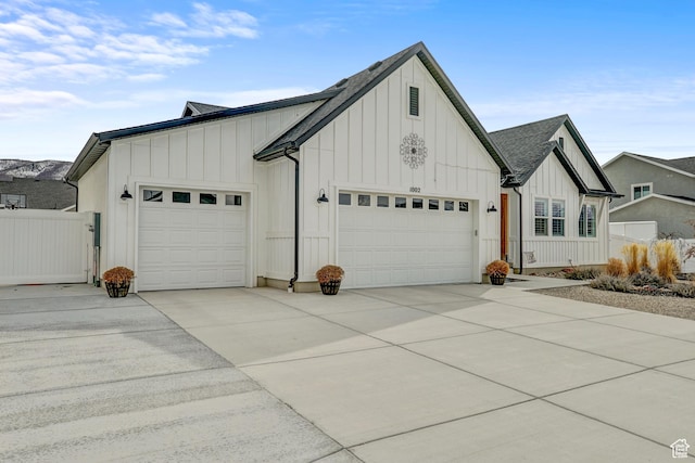 1002 E 2680 S, Heber City, UT 84032 - exterior space with a gate, roof with shingles, concrete driveway, an attached garage, and board and batten siding