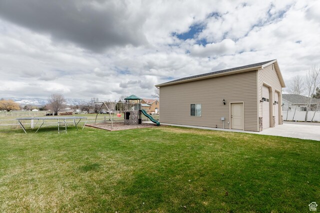 787 S 2nd W, Preston, ID 83263 - view of yard featuring fence, a playground, a garage, a trampoline, and driveway