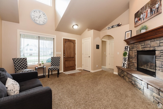 787 S 2nd W, Preston, ID 83263 - living room with high vaulted ceiling, baseboards, carpet floors, arched walkways, and a fireplace
